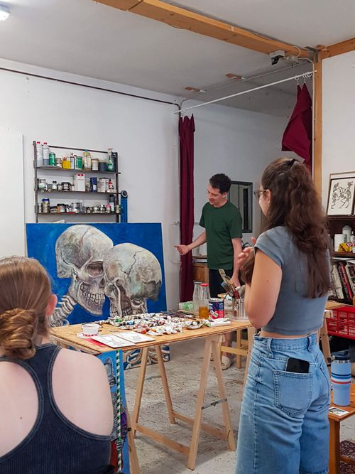 Students painting at easels in the studio