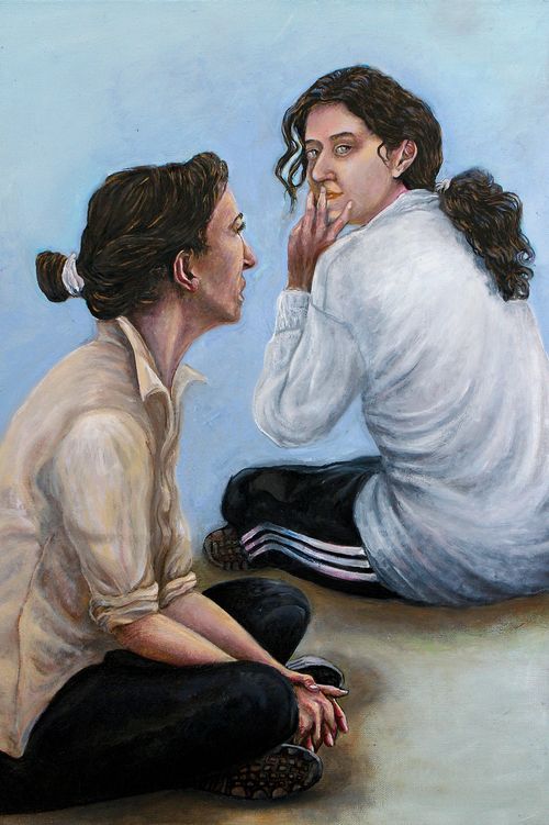 A painting of two women sitting on the ground. t tubes, brushes, mixing paletteand easel.