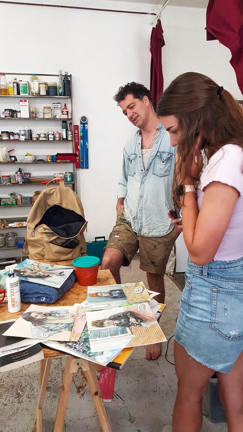 Artist working with mentor on technique