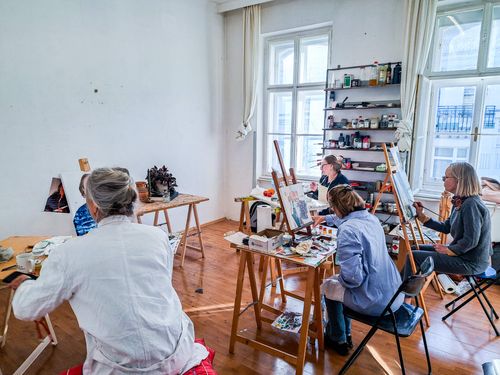 Paintings in progress during an intensive workshop session